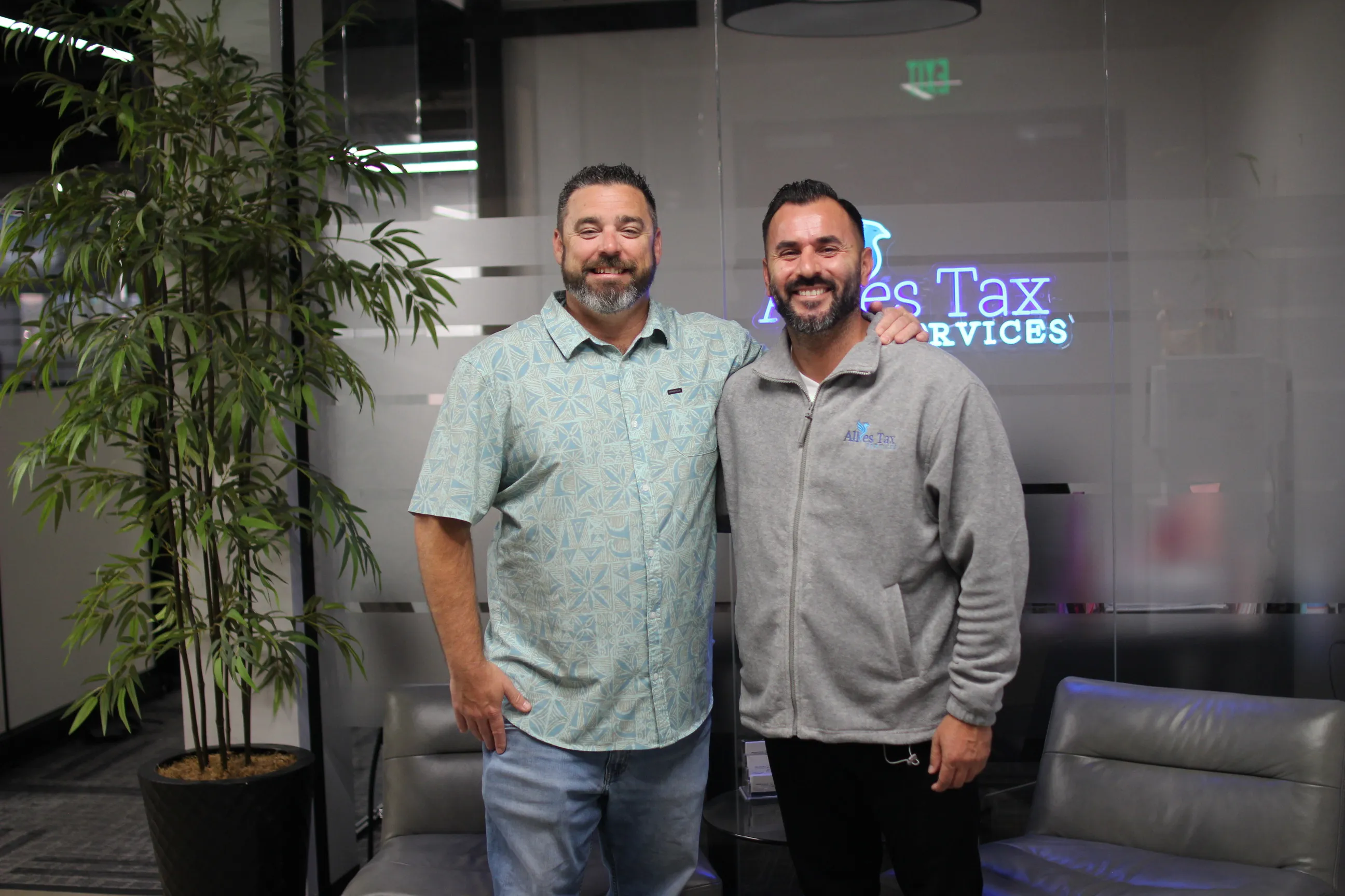 Allies Tax Services client Steve K. standing with a member of the Allies team in the Allies Tax Services office.